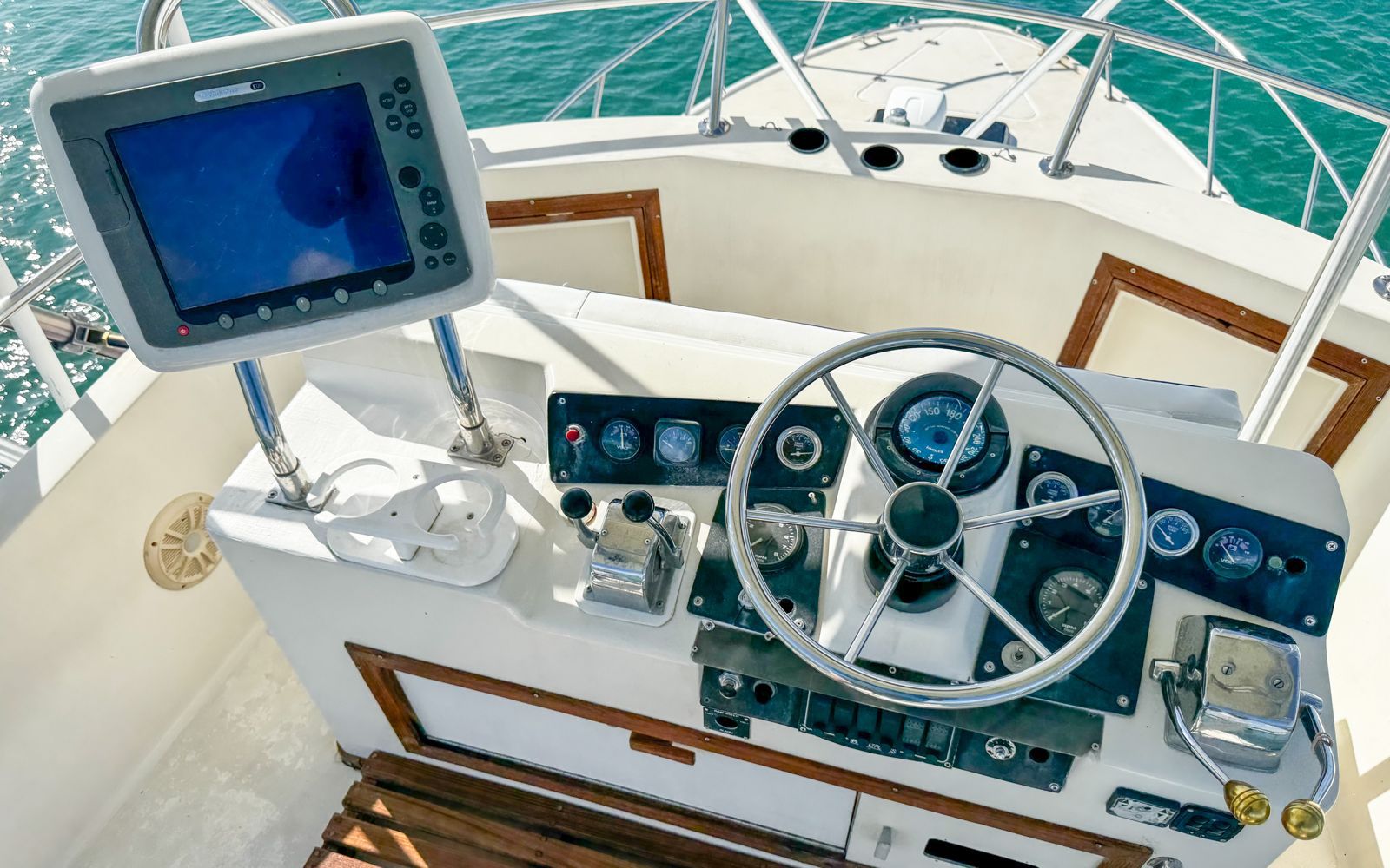 Captain at the helm and controls of the Riviera 32